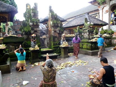 Offerings and prayer, Ubud, Bali.