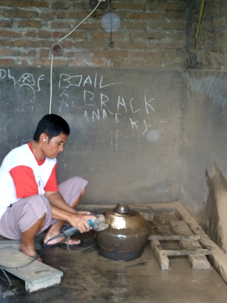 A worker burnishes a gong at the gamelan factory in Bekonang, Java. A worker burnishes a gong at the gamelan factory in Bekonang, Java.