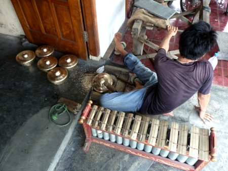 A worker goofs off at the gamelan factory in Bekonang, Java. A worker goofs off at the gamelan factory in Bekonang, Java.
