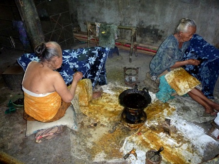 Traditional batik making with wax in Solo, Java. Traditional batik making with wax in Solo, Java.