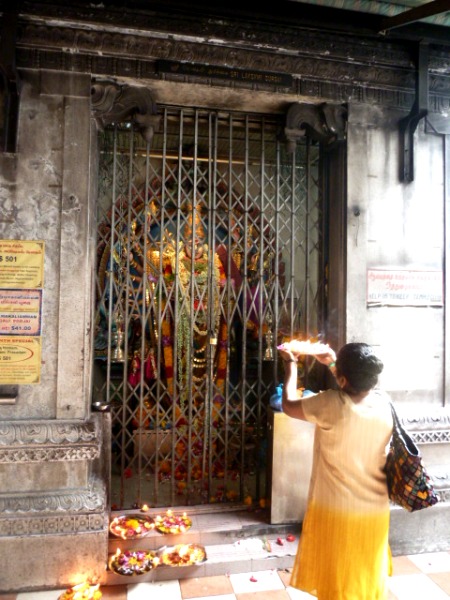 A devotee offers up some fire at the Sri Veeramakaliamman Temple in Little India, Singapore. A devotee offers up some fire at the Sri Veeramakaliamman Temple in Little India, Singapore.