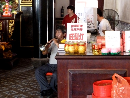 A horn player and a drummer on the right provide the music for a prayer service at the Thian Hock Keng Temple in Chinatown, Singapore. A horn player and a drummer on the right provide the music for a prayer service at the Thian Hock Keng Temple in Chinatown, Singapore.