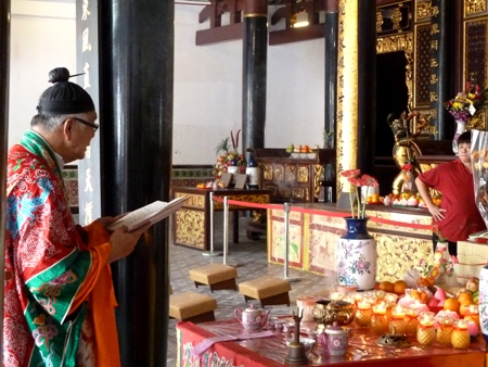 A priest conducts a Buddhist prayer service at the Thian Hock Keng Temple in Chinatown, Singapore. A priest conducts a Buddhist prayer service at the Thian Hock Keng Temple in Chinatown, Singapore.