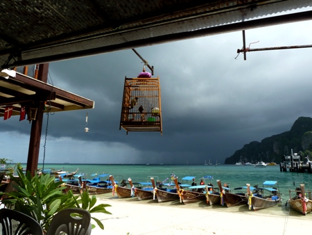 A torrential rainstorm falls upon the open sea out beyond Ao Ton Sai Bay, Ko Phi Phi Don, Thailand.
