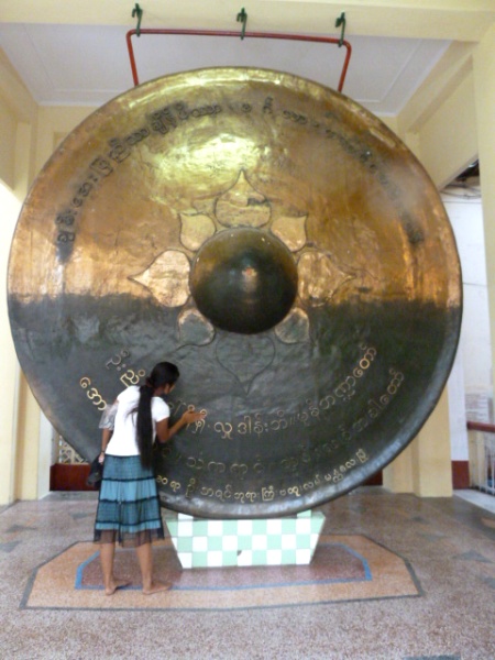 A local polishes the world's biggest gong--maybe--at the Mahamuni Pagoda compound in Mandalay, Myanmar. A local polishes the world's biggest gong--maybe--at the Mahamuni Pagoda compound in Mandalay, Myanmar.