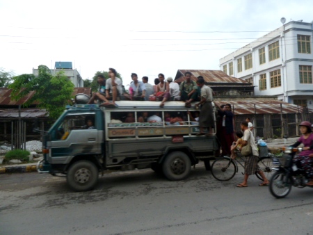 Rooftop riders in Mandalay, Myanmar. Rooftop riders in Mandalay, Myanmar.
