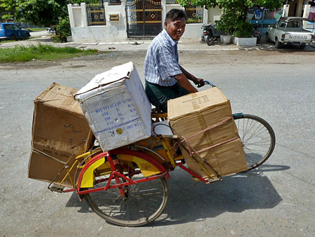 When fares dry up, trishaw drivers resort to the transport of goods in Mandalay, Myanmar.