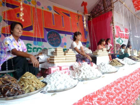Ladies all posted up and selling sweets at the nat pwe in Taungbyone, Myanmar. Ladies all posted up and selling sweets at the nat pwe in Taungbyone, Myanmar.
