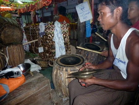 Close-up on another cymbal player and a drummer at the nat pwe in Taungbyone, Myanmar. Close-up on another cymbal player and a drummer at the nat pwe in Taungbyone, Myanmar.