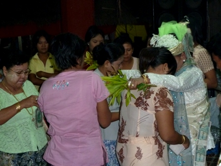 A nat kadaw performs services for a congregation at the nat pwe in Taungbyone, Myanmar. A nat kadaw performs services for a congregation at the nat pwe in Taungbyone, Myanmar.