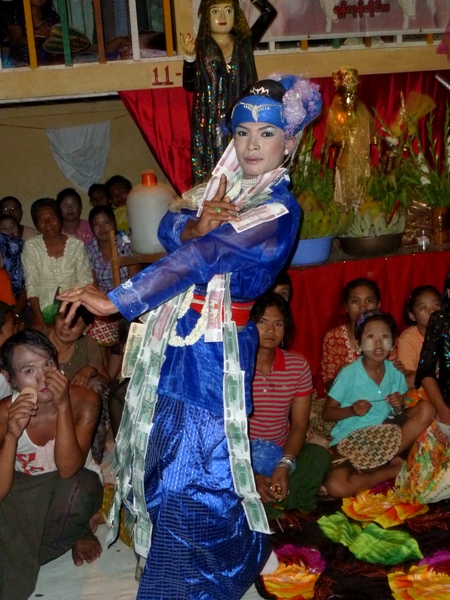 It doesn't get any more stylish than this! A nat kadaw busts a move in front of the faithful at the nat pwe in Taungbyone, Myanmar. It doesn't get any more stylish than this! A nat kadaw busts a move in front of the faithful at the nat pwe in Taungbyone, Myanmar.