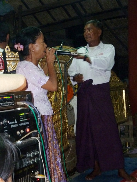 A little lady belts out a big tune at the nat pwe in Taungbyone, Myanmar. A little lady belts out a big tune at the nat pwe in Taungbyone, Myanmar.
