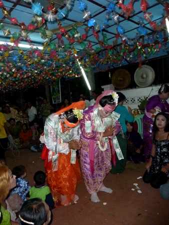 A flamboyant ceiling is easily overshadowed by two brightly attired nat kadaws at the nat pwe in Taungbyone, Myanmar. A flamboyant ceiling is easily overshadowed by two brightly attired nat kadaws at the nat pwe in Taungbyone, Myanmar.