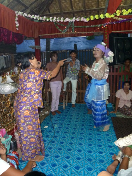 A singer eggs on a nat kadaw at the nat pwe in Taungbyone, Myanmar. A singer eggs on a nat kadaw at the nat pwe in Taungbyone, Myanmar.