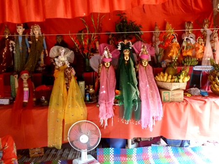 The Taungbyone brothers, in pink, flank their mother, in green, at the nat pwe in Taungbyone, Myanmar. The Taungbyone brothers, in pink, flank their mother, in green, at the nat pwe in Taungbyone, Myanmar.