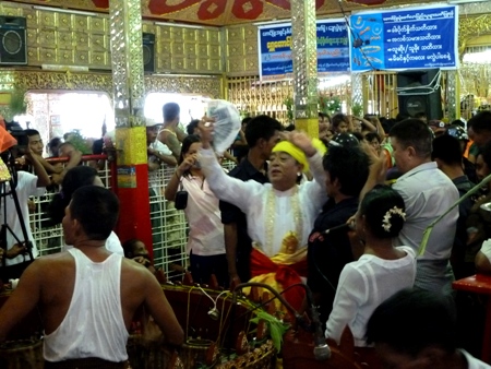 A nat kadaw performs his services in the main temple at the nat pwe in Taungbyone, Myanmar. A nat kadaw performs his services in the main temple at the nat pwe in Taungbyone, Myanmar.
