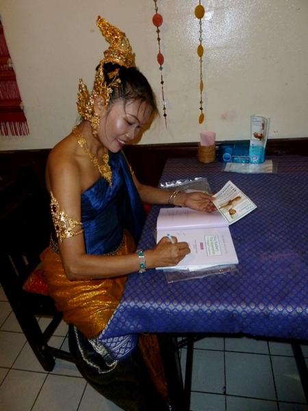 May Kaidee signs copies of her cookbook at her restaurant in Banglamphu, Bangkok, Thailand. May Kaidee signs copies of her cookbook at her restaurant in Banglamphu, Bangkok, Thailand.
