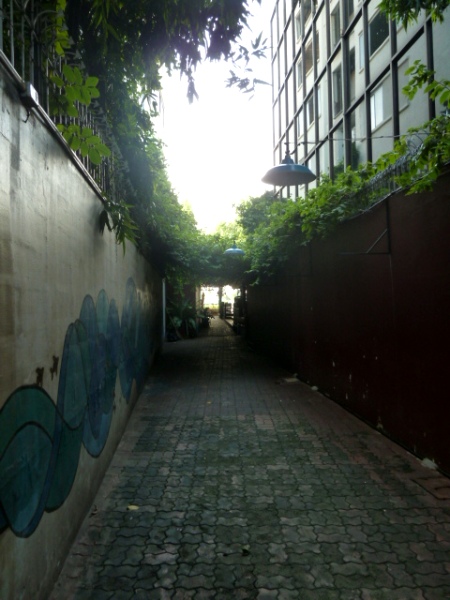 An alley leading to Phra Ahtit pier on the Chao Phraya river in Bangkok, Thailand.