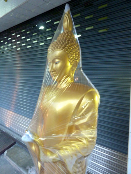 Plastic Buddha, meet plastic shrinkwrap. Bangkok, Thailand.