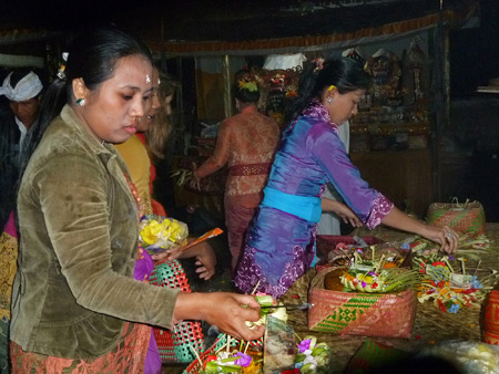 Grabbing some offerings at a Hindu temple ceremony in Bangli, Bali, Indonesia.