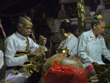 A priest conducts an offering ritual at a Hindu temple ceremony in Bangli, Bali, Indonesia.