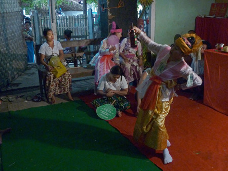 An alcohol-fueled nat kadaw performs at the Nat Pwe in Taungbyone, Myanmar.