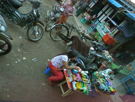 Snack sellers as seen from the bus window at the terminal in Mandalay, Myanmar.
