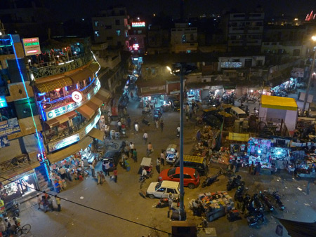 A nighttime overview of the Main Bazaar area of Paharganj, Delhi, India.