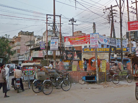 A triangular-shaped traffic island at a three-way intersection on Chowk Godowlia Road in Varanasi, India.