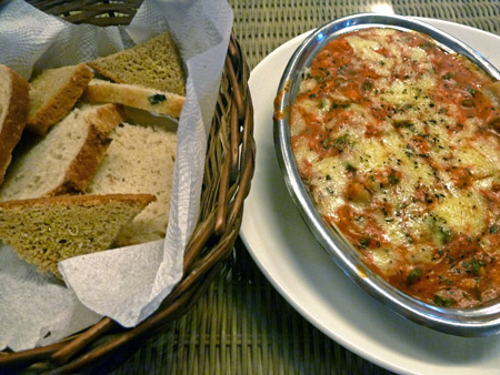 Yummy veggie lasagne and baguette slices at the Brown Bread Bakery in Paharganj, Delhi, India.
