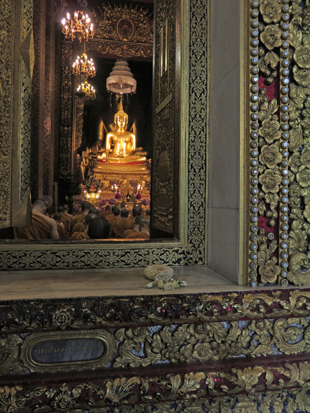 An evening Buddhist prayer service at Wat Bowonniwet in Banglamphu, Bangkok, Thailand.