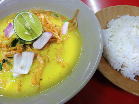 Yellow curry with noodles and rice at a restaurant on Soi 38 in Sukhumvit, Bangkok, Thailand.
