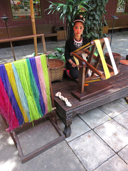 A woman looms silk at Jim Thompson's House near Siam Square, Bangkok, Thailand.