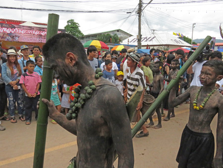 A primitive tribe marches by in the parade at the Phi Ta Khon festival in Dan Sai, Thailand.