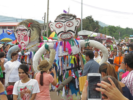 Demons stalk the parade at the Phi Ta Khon festival in Dan Sai, Thailand.