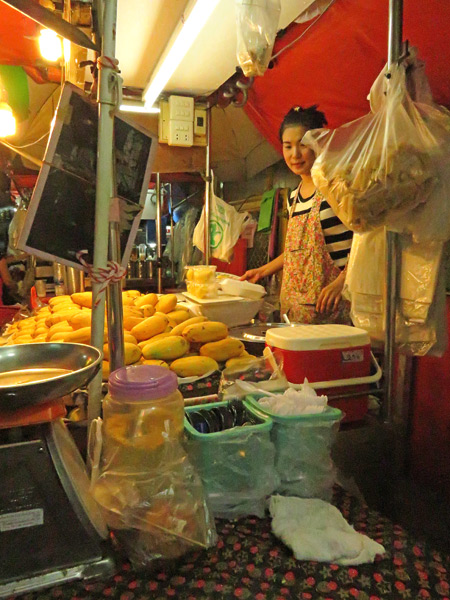 A food stall selling mango and sticky rice on Sukhumvit Soi 38 in Bangkok, Thailand.