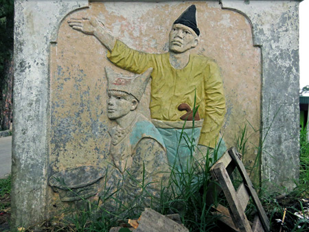 A carving of traditional Minangkabau musicians on a small booth near the entrance to Fort de Kock in Bukittinggi, Sumatra, Indonesia.