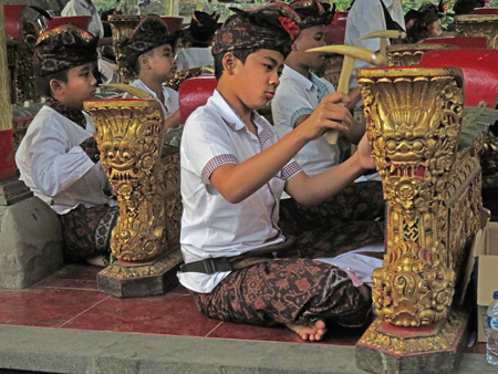 A young boys' gamelan plays during a Hindu temple ceremony at Pura Desa in Ubud, Bali, Indonesia.