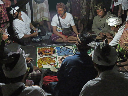 Men gamble during a board game at a Hindu temple ceremony at Pura Desa in Ubud, Bali, Indonesia.