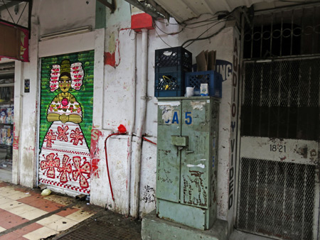 A painting of a Pollera dancer on a roll-up door in Ancon, Panama City, Panama.