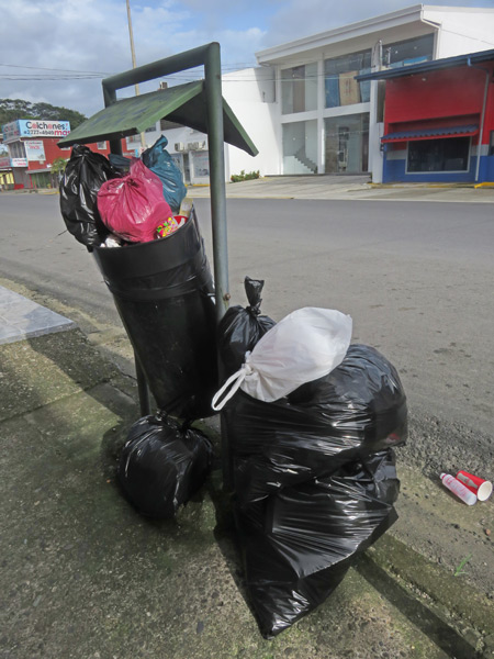 Total trash shrouded in black plastic in Quepos, Costa Rica.