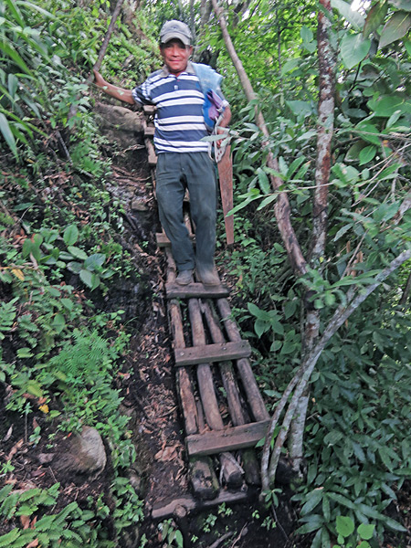The Happy Gate Man descends a rickety ladder on the trail down from Indian's Nose at Lago de Atitlan, Guatemala.