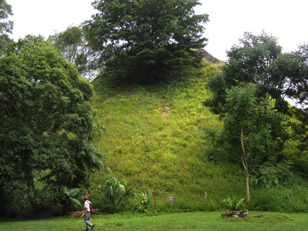 The overgrown backside of the Lost World Pyramid in the Mundo Perdido complex at Tikal, Guatemala.