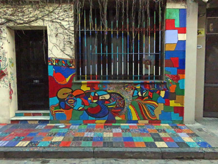 A color-splashed wall and sidewalk in Palermo Soho, Buenos Aires, Argentina.