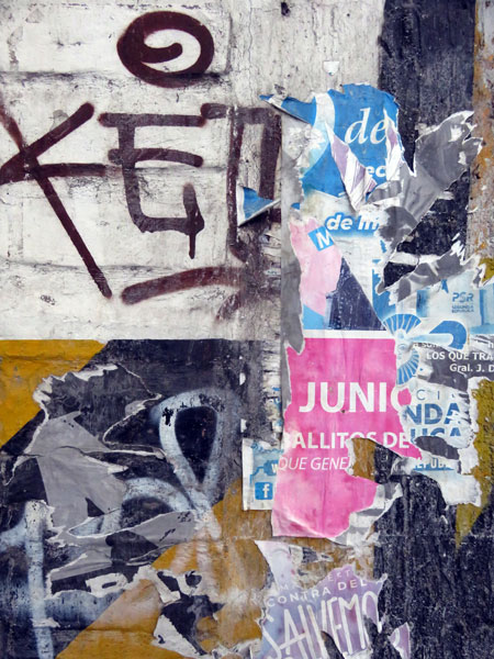 Graffiti and torn flyers in Mendoza, Argentina.