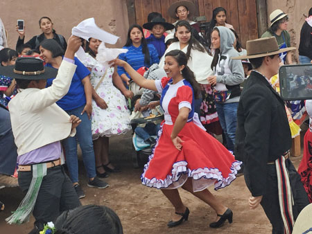 A parade celebrating Chilean Independence Day stops for a round of dancing in the streets of San Pedro de Atacama, Chile.