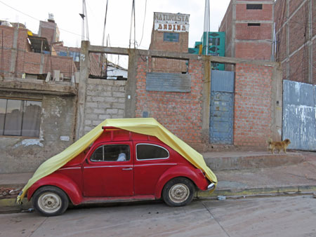 A Volkswagen Beetle all bundled up in Puno, Peru.