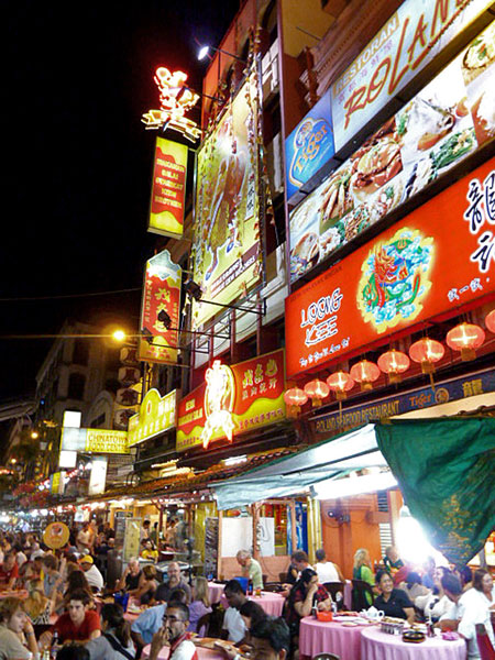 Some bright signs blaze through the night in Chinatown, Kuala Lumpur, Malaysia.