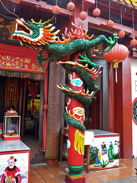 A fierce dragon guards a Chinese Buddhist temple in Melaka, Malaysia.