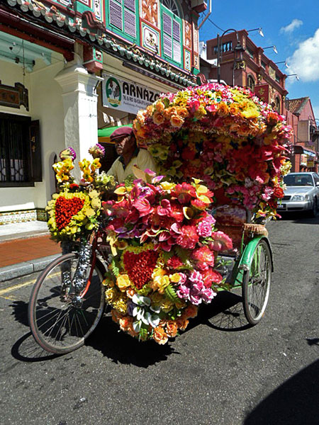 A psychedelic trishaw brightens the day in Melaka, Malaysia.